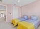Bedroom with two twin beds and light pink walls at 1009 Wood Cv, Kissimmee, FL 34743