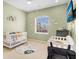 Bedroom with crib, changing table, and calming decor at 1009 Wood Cv, Kissimmee, FL 34743