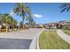 Gated entrance to community featuring lush landscaping and palm trees at 1009 Wood Cv, Kissimmee, FL 34743