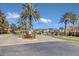 Gated community entrance with palm trees and brick pavers at 1009 Wood Cv, Kissimmee, FL 34743