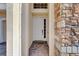 Front entry with a white door and brick columns at 1009 Wood Cv, Kissimmee, FL 34743