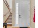 Inviting entryway with staircase and frosted glass window at 1009 Wood Cv, Kissimmee, FL 34743