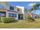 Townhouse exterior with landscaped yard and screened patio at 1009 Wood Cv, Kissimmee, FL 34743