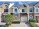Two-story townhouse with stone facade and a paved driveway at 1009 Wood Cv, Kissimmee, FL 34743