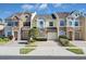 Three-story townhouses with stone accents and attached garages at 1009 Wood Cv, Kissimmee, FL 34743