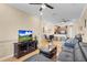 Spacious living room featuring hardwood floors, comfortable seating, and a view into the kitchen at 1009 Wood Cv, Kissimmee, FL 34743