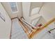 Elegant staircase with wood railing and carpeted steps at 1009 Wood Cv, Kissimmee, FL 34743
