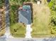 Aerial view of a home with a private screened-in pool, well-manicured lawn, and driveway at 1150 Eden Dr, St Cloud, FL 34771