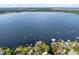 Expansive aerial view of a lakefront community with docks, lush greenery, and calm waters at 1150 Eden Dr, St Cloud, FL 34771