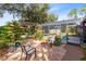 Charming backyard patio featuring brick pavers, comfortable seating, and mature landscaping at 1150 Eden Dr, St Cloud, FL 34771