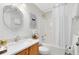 Bright bathroom featuring a bathtub, shower, wooden vanity, and decorative mirror enhancing the overall space at 1150 Eden Dr, St Cloud, FL 34771