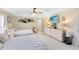 Spacious bedroom with dual beds, a ceiling fan, ample natural light, and a bright airy feel at 1150 Eden Dr, St Cloud, FL 34771