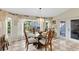 Bright dining area with backyard view, checkered tile floors, and seating for four at 1150 Eden Dr, St Cloud, FL 34771