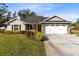 Charming single-Gathering home with manicured lawn and two-car garage at 1150 Eden Dr, St Cloud, FL 34771