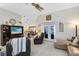 Bright living room featuring tile floors, a ceiling fan, and double doors leading to the outdoors at 1150 Eden Dr, St Cloud, FL 34771