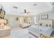 Spacious main bedroom with two beds, ceiling fan, light walls, and neutral decor at 1150 Eden Dr, St Cloud, FL 34771