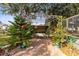 Cozy brick patio featuring a covered swing with decorative plants and a lush garden setting at 1150 Eden Dr, St Cloud, FL 34771