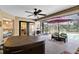Relaxing screened patio with hot tub, ample seating, and an umbrella for shade at 1150 Eden Dr, St Cloud, FL 34771