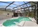 Sparkling pool with screened enclosure, lush greenery, and ample patio space at 1150 Eden Dr, St Cloud, FL 34771