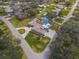 Aerial view of a home with a pool and circular driveway, nestled among mature trees at 123 Lakeview Dr, Auburndale, FL 33823