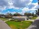 Aerial view of a well-maintained single-story home with a green lawn and mature trees at 123 Lakeview Dr, Auburndale, FL 33823
