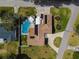 Aerial view of property featuring a private pool, circular driveway, and professionally landscaped yard at 123 Lakeview Dr, Auburndale, FL 33823