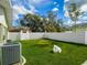 Fenced backyard area with grass and an AC unit at 123 Lakeview Dr, Auburndale, FL 33823