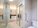 Bathroom features a vanity with a black countertop, a tiled floor, and a large walk-in shower at 123 Lakeview Dr, Auburndale, FL 33823