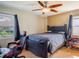 Bedroom with a dark wood bed frame, a ceiling fan, and a view to the outside at 123 Lakeview Dr, Auburndale, FL 33823