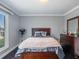 Comfortable bedroom with wood floors, natural light, a fan and dresser at 123 Lakeview Dr, Auburndale, FL 33823