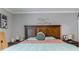 Comfortable main bedroom featuring a decorative headboard, bedside tables, and soft lighting at 123 Lakeview Dr, Auburndale, FL 33823