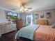 This bedroom features dark hardwood floors, a ceiling fan, and lots of natural light at 123 Lakeview Dr, Auburndale, FL 33823