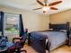 Bedroom features a ceiling fan, a computer, and a window to the outside at 123 Lakeview Dr, Auburndale, FL 33823