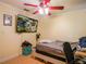 Cozy bedroom with a red ceiling fan and walls painted in neutral tones at 123 Lakeview Dr, Auburndale, FL 33823