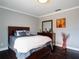 This bedroom features dark hardwood floors, light-colored walls, and lots of natural light at 123 Lakeview Dr, Auburndale, FL 33823