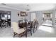 Elegant dining room with a large table, seating for six, and a stylish mirrored buffet at 123 Lakeview Dr, Auburndale, FL 33823