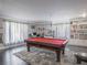 Bright game room with a pool table, built-in shelving, and neutral decor at 123 Lakeview Dr, Auburndale, FL 33823