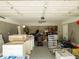 Spacious garage with abundant storage and work areas, featuring a ceiling fan at 123 Lakeview Dr, Auburndale, FL 33823