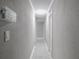 Hallway features tile floors, neutral gray paint, and white trim at 123 Lakeview Dr, Auburndale, FL 33823