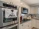 Modern kitchen features stainless steel appliances, granite countertops, white cabinets, and a stylish backsplash at 123 Lakeview Dr, Auburndale, FL 33823