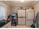 A functional laundry room with washer, dryer, storage cabinets, and ample cleaning supplies at 123 Lakeview Dr, Auburndale, FL 33823