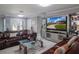 Spacious living room with a large television, leather sofas, and a glass coffee table at 123 Lakeview Dr, Auburndale, FL 33823