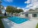 Inviting backyard pool with a white canopy featuring entertainment furniture, perfect for relaxation and gatherings at 123 Lakeview Dr, Auburndale, FL 33823