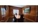 Formal dining room with dark wood paneling, table, and chairs at 14214 Fredricksburg Dr # 106, Orlando, FL 32837