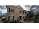 Charming home showcasing a two-story design, complemented by a quaint balcony and meticulously maintained landscaping at 14214 Fredricksburg Dr # 106, Orlando, FL 32837