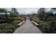 Beautifully landscaped walkway leading to the home, surrounded by lush greenery at 14214 Fredricksburg Dr # 106, Orlando, FL 32837