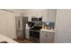 Modern kitchen featuring stainless steel appliances, gray cabinets, and a stylish countertop with ample workspace at 14214 Fredricksburg Dr # 106, Orlando, FL 32837