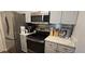 Well-equipped kitchen boasting stainless steel appliances and light gray cabinets for a modern, clean look at 14214 Fredricksburg Dr # 106, Orlando, FL 32837