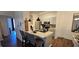 Modern eat-in kitchen featuring stainless steel appliances, a breakfast bar, and ample counter space at 14214 Fredricksburg Dr # 106, Orlando, FL 32837