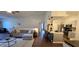 Open-concept living room and kitchen with hardwood floors, modern decor, and bar-style seating at the kitchen counter at 14214 Fredricksburg Dr # 106, Orlando, FL 32837
